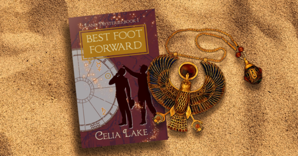 Copy of Best Foot Forward lying on a bed of sand, covered by an enamelled Horus medallion. The cover has a deep red background with map markings in a dull purple. Two men in silhouette stand, looking up at a point in the top left. An astrology chart with different symbols picked out takes up the left side of the image, with glowing stars curving up to the title.